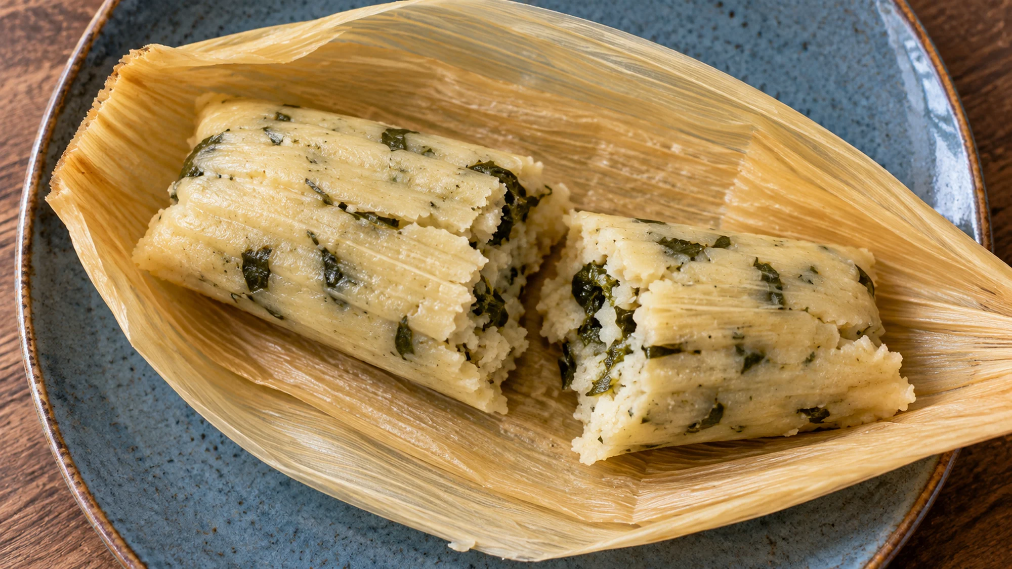 Chipilín tamales broken open to show tender green-flecked masa